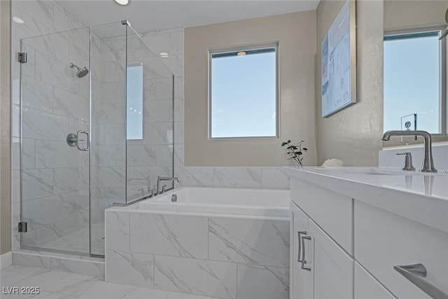 2246 Bird Of Prey St, Las Vegas, NV 89138 - full bath featuring a garden tub, vanity, a marble finish shower, and marble look tile flooring