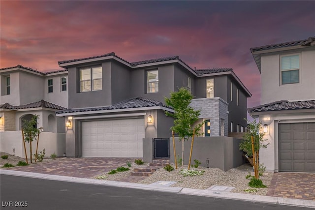 2246 Bird Of Prey St, Las Vegas, NV 89138 - mediterranean / spanish-style house with an attached garage, stucco siding, and decorative driveway