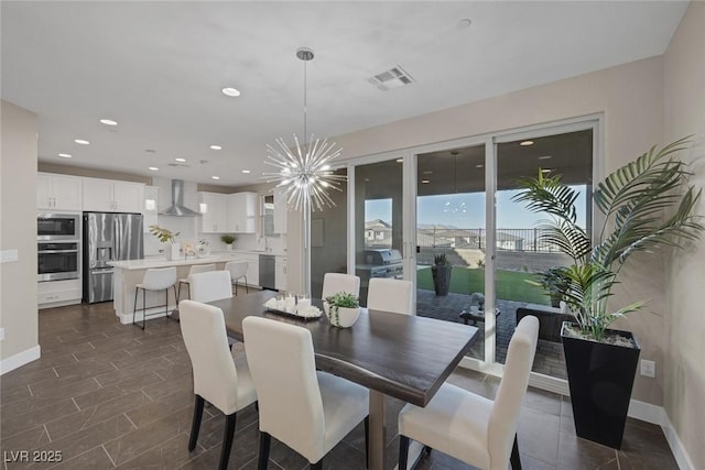 2246 Bird Of Prey St, Las Vegas, NV 89138 - dining room featuring a chandelier, recessed lighting, and baseboards