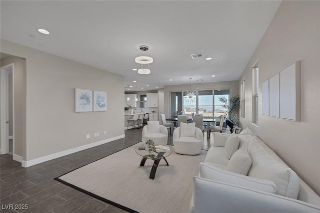 2246 Bird Of Prey St, Las Vegas, NV 89138 - living area featuring a chandelier, recessed lighting, and baseboards