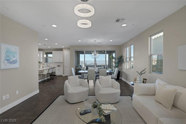2246 Bird Of Prey St, Las Vegas, NV 89138 - living room featuring a chandelier, baseboards, recessed lighting, and wood tiled floors