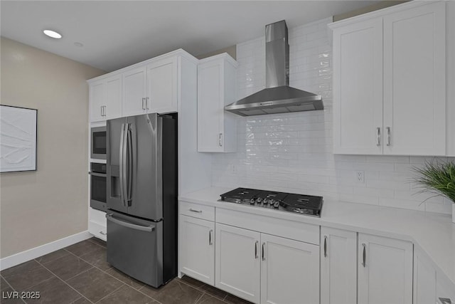 2246 Bird Of Prey St, Las Vegas, NV 89138 - kitchen with appliances with stainless steel finishes, wall chimney range hood, light countertops, white cabinets, and baseboards