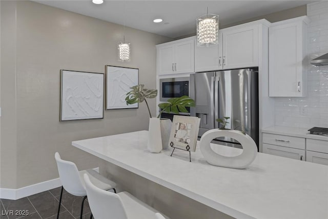 2246 Bird Of Prey St, Las Vegas, NV 89138 - kitchen featuring stainless steel appliances, white cabinetry, tasteful backsplash, light countertops, and recessed lighting