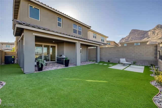 2246 Bird Of Prey St, Las Vegas, NV 89138 - rear view of house with a patio area, central AC unit, stucco siding, and a tiled roof