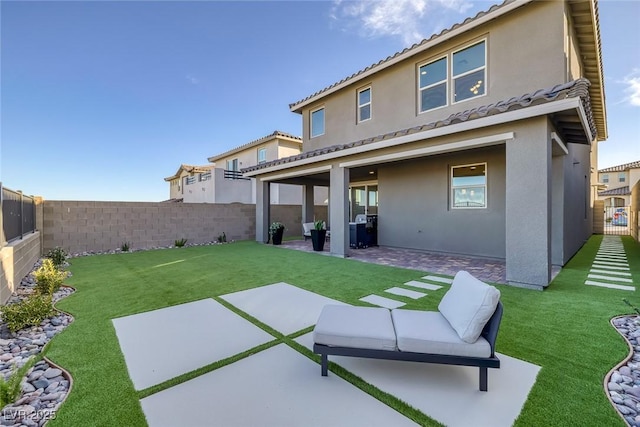 2246 Bird Of Prey St, Las Vegas, NV 89138 - rear view of house with stucco siding, a patio, and a tiled roof