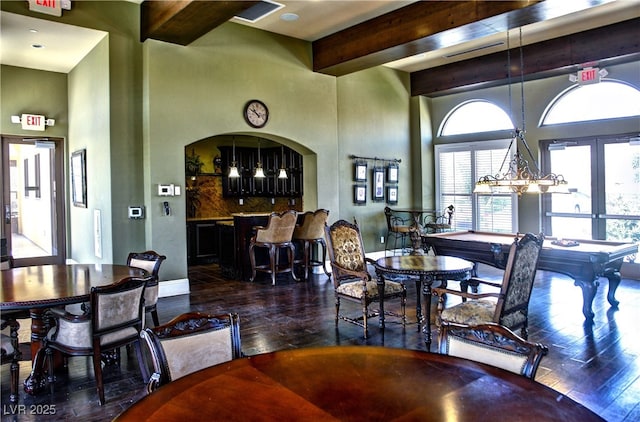 dining area with hardwood / wood-style floors, beam ceiling, a high ceiling, french doors, and billiards table