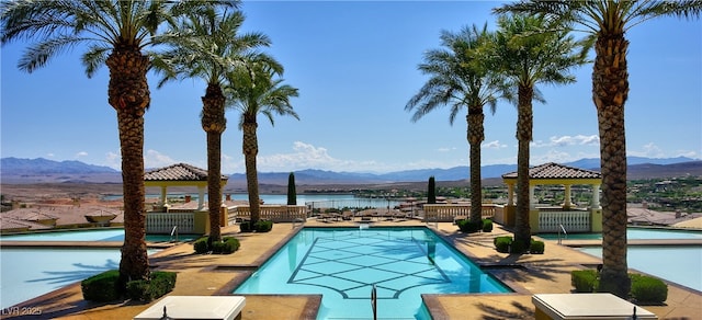 community pool with a gazebo and a water and mountain view