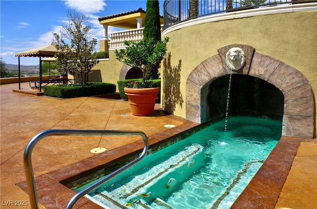 view of pool featuring a gazebo and a patio area