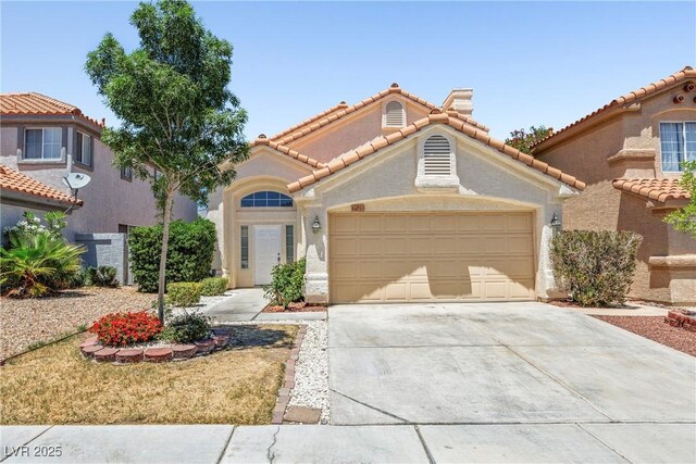 9520 Rancho Palmas Dr, Las Vegas, NV 89117 - mediterranean / spanish house with driveway, an attached garage, a tile roof, and stucco siding