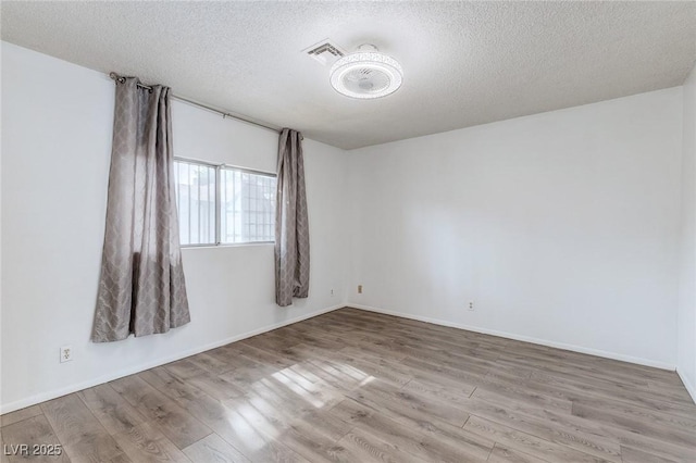 875 Rhinegold Way, Las Vegas, NV 89110 - spare room with wood finished floors, a textured ceiling, and baseboards
