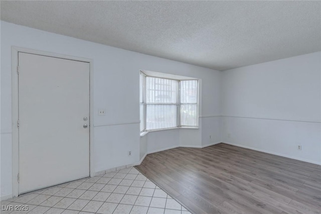 875 Rhinegold Way, Las Vegas, NV 89110 - spare room with light wood finished floors, a textured ceiling, and baseboards