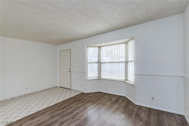 875 Rhinegold Way, Las Vegas, NV 89110 - empty room with wood finished floors, a textured ceiling, and baseboards