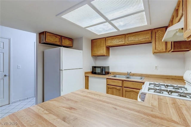 875 Rhinegold Way, Las Vegas, NV 89110 - kitchen featuring a sink, white appliances, under cabinet range hood, light countertops, and light tile patterned floors