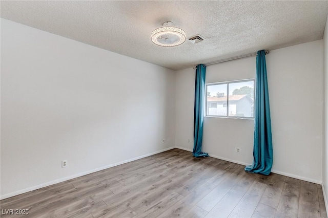 875 Rhinegold Way, Las Vegas, NV 89110 - spare room with wood finished floors, a textured ceiling, and baseboards