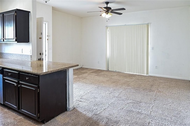 5650 E Sahara Ave Unit 2062, Las Vegas, NV 89142 - kitchen featuring dark cabinets, a ceiling fan, light carpet, and baseboards