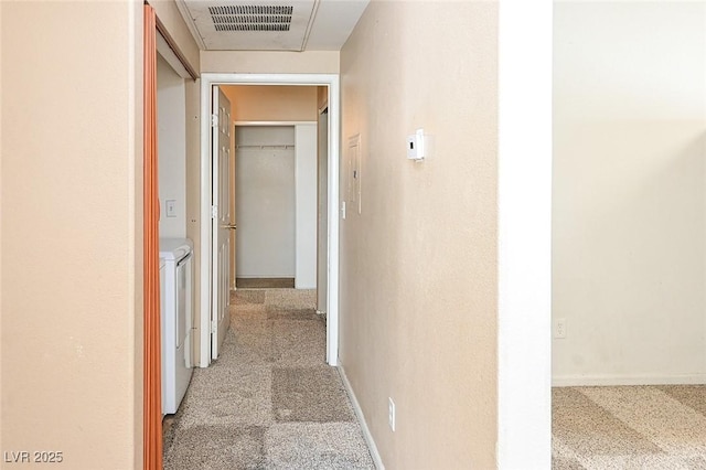 5650 E Sahara Ave Unit 2062, Las Vegas, NV 89142 - hallway featuring washer and dryer, carpet floors, and baseboards
