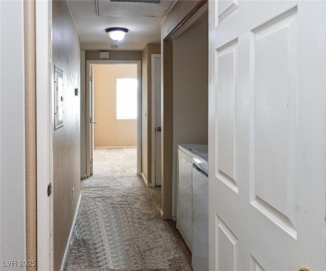 5650 E Sahara Ave Unit 2062, Las Vegas, NV 89142 - hallway featuring light colored carpet and washing machine and clothes dryer