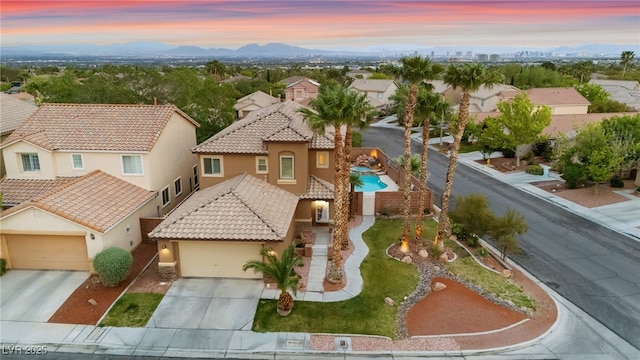 aerial view at dusk of a residential view and a mountain view
