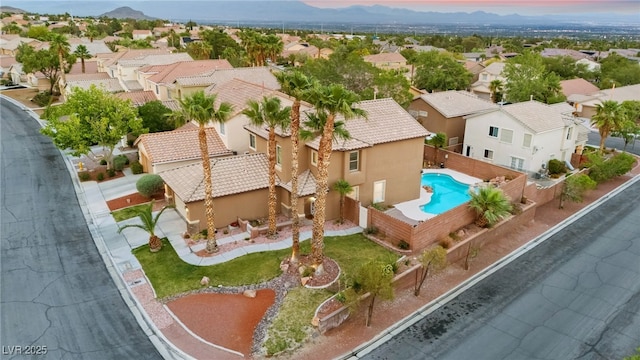 aerial view of residential area featuring a pool and mountains