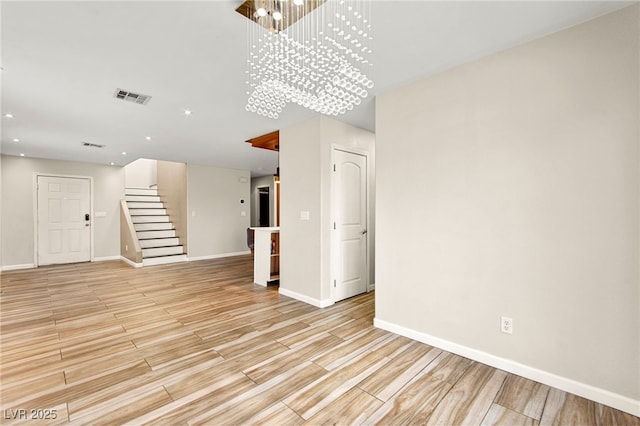 unfurnished living room featuring stairs, baseboards, light wood-style flooring, a chandelier, and recessed lighting