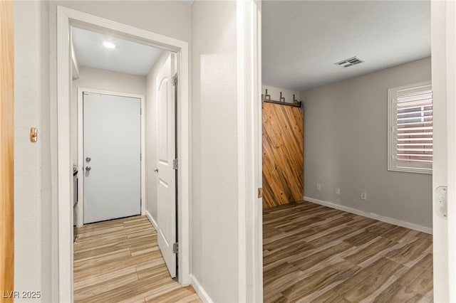 hallway with light wood-style floors and baseboards