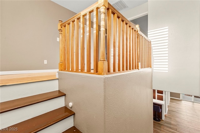 stairs with wood finished floors