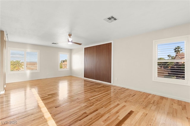 unfurnished bedroom featuring light wood-type flooring, baseboards, a closet, and a ceiling fan