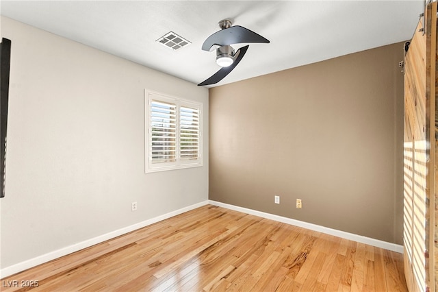 empty room featuring light wood-type flooring and baseboards
