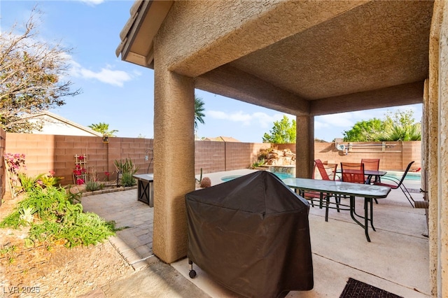 view of patio / terrace with outdoor dining area, area for grilling, and a fenced backyard