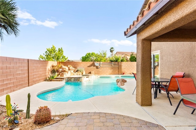 view of swimming pool with a fenced backyard, a patio area, and a pool with connected hot tub
