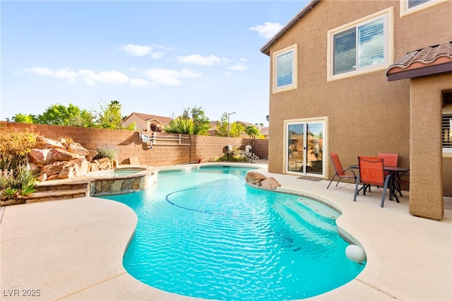 view of pool with a fenced backyard, a patio, and a pool with connected hot tub