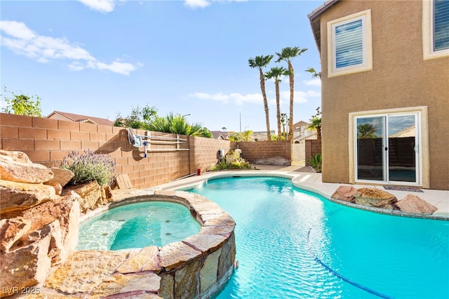 view of pool with a fenced backyard and a pool with connected hot tub