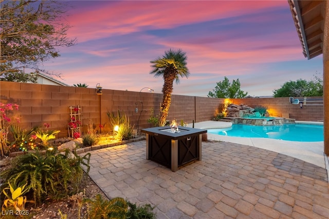 view of patio featuring an outdoor fire pit and a fenced backyard