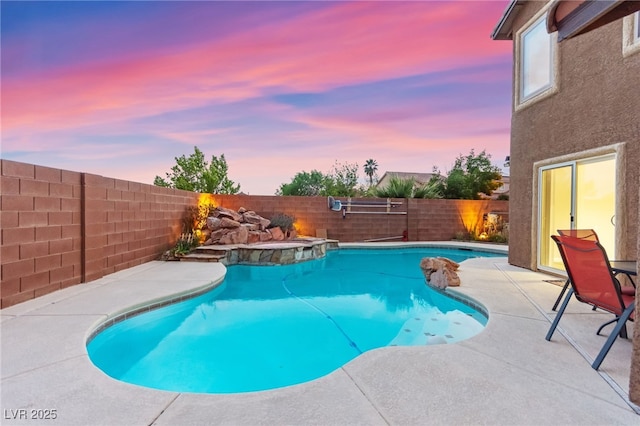 view of swimming pool featuring a fenced backyard and a patio area