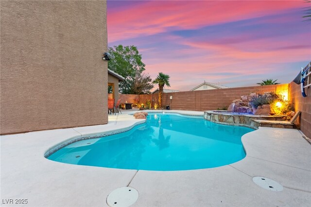 1200 Dream Bridge Dr, Las Vegas, NV 89144 - pool at dusk with a patio area, a fenced backyard, and a pool with connected hot tub