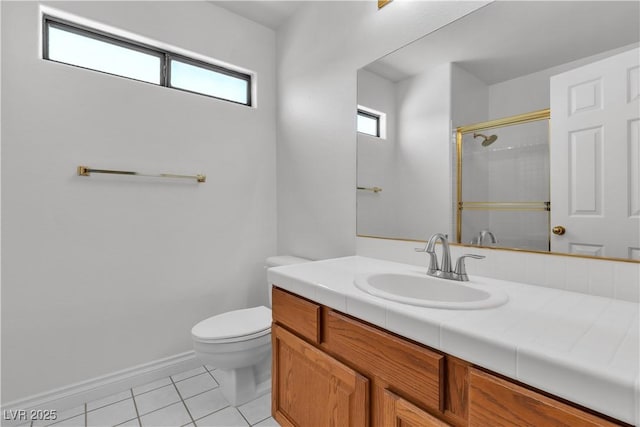 8437 Apple Hill Ct, Las Vegas, NV 89128 - bathroom featuring toilet, tile patterned flooring, a shower with door, vanity, and baseboards