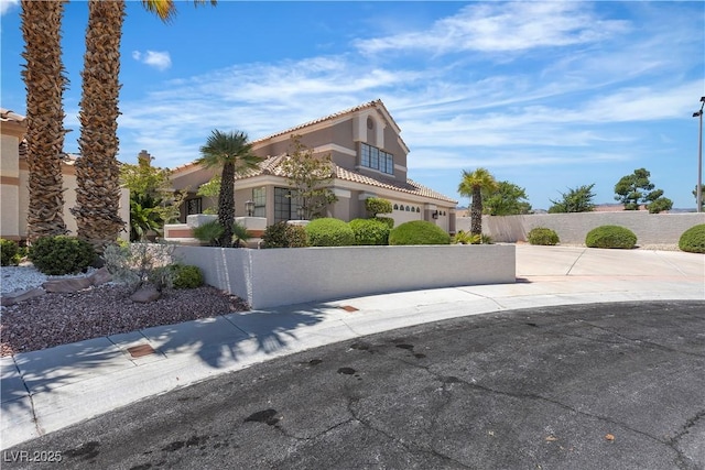 8437 Apple Hill Ct, Las Vegas, NV 89128 - view of side of property with a fenced front yard, a tiled roof, and stucco siding