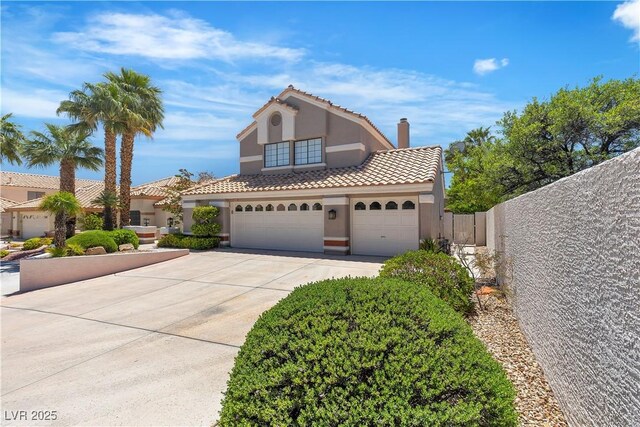 8437 Apple Hill Ct, Las Vegas, NV 89128 - mediterranean / spanish-style house with stucco siding, driveway, a tiled roof, fence, and an attached garage