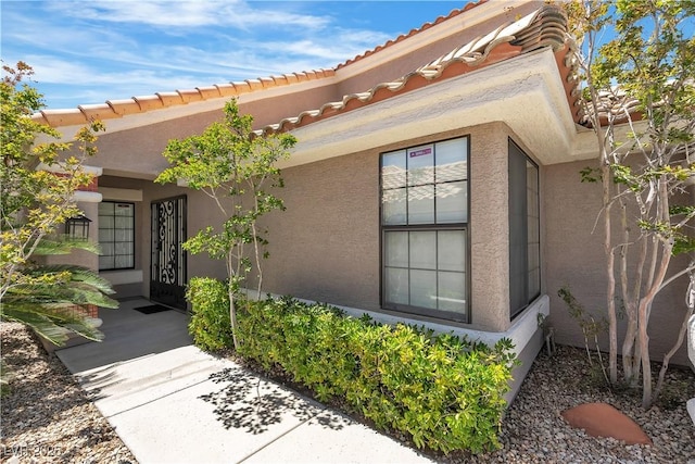 8437 Apple Hill Ct, Las Vegas, NV 89128 - entrance to property featuring stucco siding and a tile roof