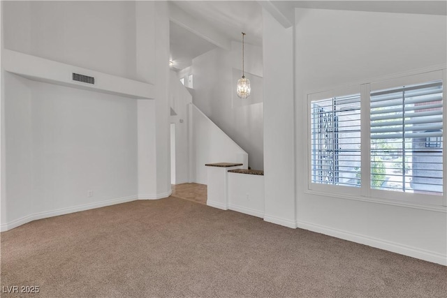 8437 Apple Hill Ct, Las Vegas, NV 89128 - unfurnished living room featuring carpet floors, beam ceiling, high vaulted ceiling, stairs, and baseboards