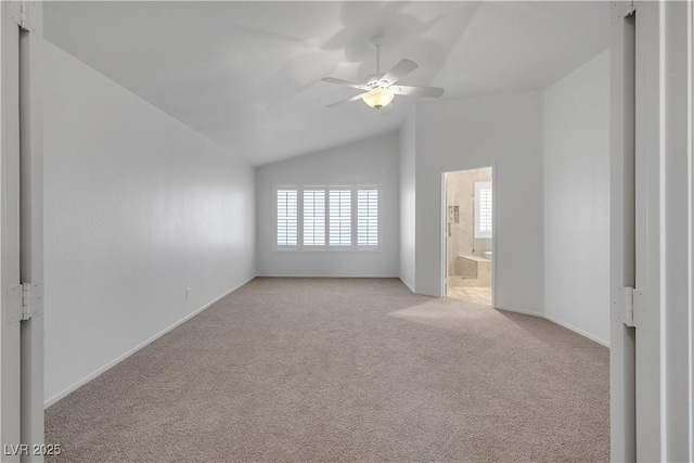8437 Apple Hill Ct, Las Vegas, NV 89128 - spare room featuring light colored carpet, ceiling fan, lofted ceiling, and baseboards