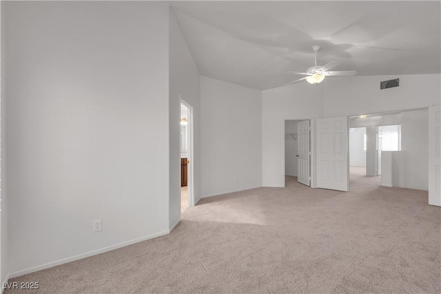 8437 Apple Hill Ct, Las Vegas, NV 89128 - unfurnished living room with light carpet, vaulted ceiling, a ceiling fan, and baseboards