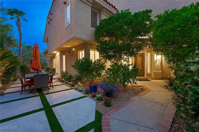 5125 Turnberry Ln, Las Vegas, NV 89113 - view of front of home featuring stucco siding, a patio area, and outdoor dining area