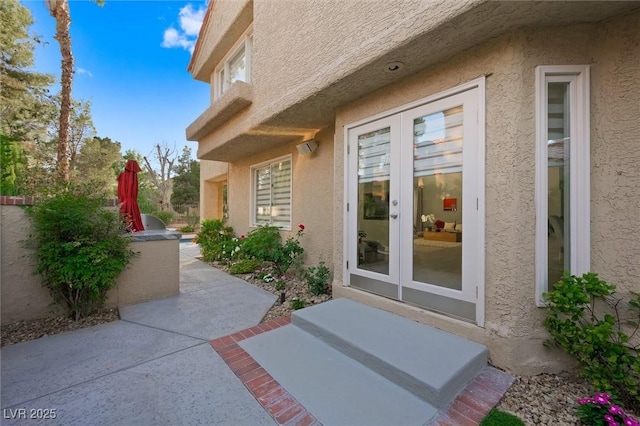 5125 Turnberry Ln, Las Vegas, NV 89113 - doorway to property with french doors, stucco siding, and a patio
