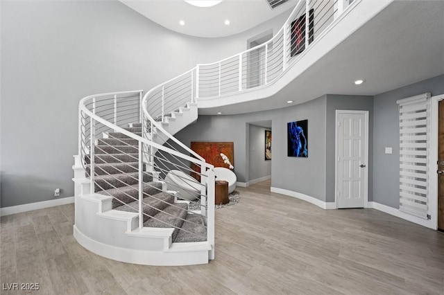 5125 Turnberry Ln, Las Vegas, NV 89113 - staircase with baseboards, a high ceiling, wood finished floors, and recessed lighting