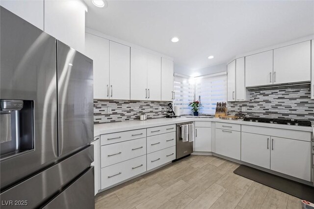 5125 Turnberry Ln, Las Vegas, NV 89113 - kitchen with appliances with stainless steel finishes, light countertops, backsplash, white cabinets, and recessed lighting