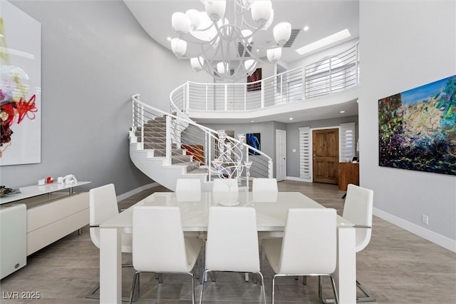 5125 Turnberry Ln, Las Vegas, NV 89113 - dining area with stairway, baseboards, a towering ceiling, a chandelier, and recessed lighting