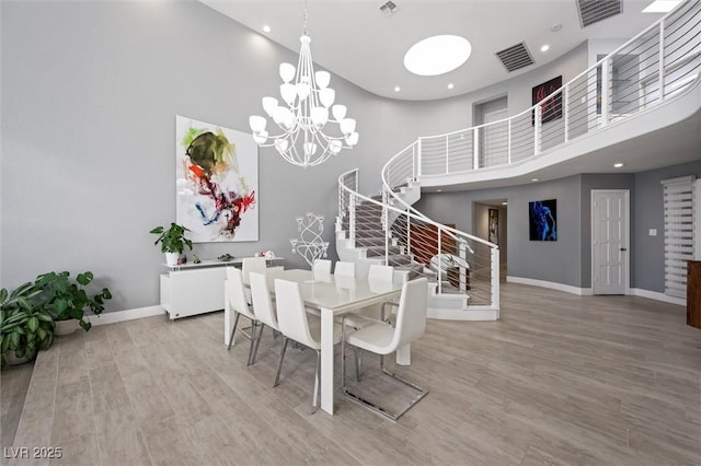 5125 Turnberry Ln, Las Vegas, NV 89113 - dining space featuring a high ceiling, baseboards, recessed lighting, stairway, and light wood finished floors