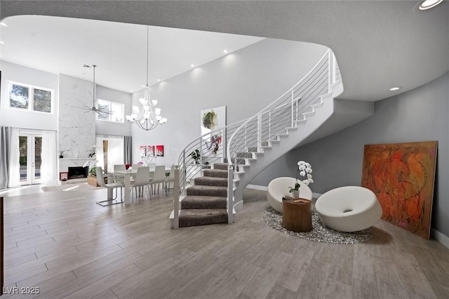 5125 Turnberry Ln, Las Vegas, NV 89113 - staircase with a towering ceiling, wood finished floors, ceiling fan, recessed lighting, and baseboards
