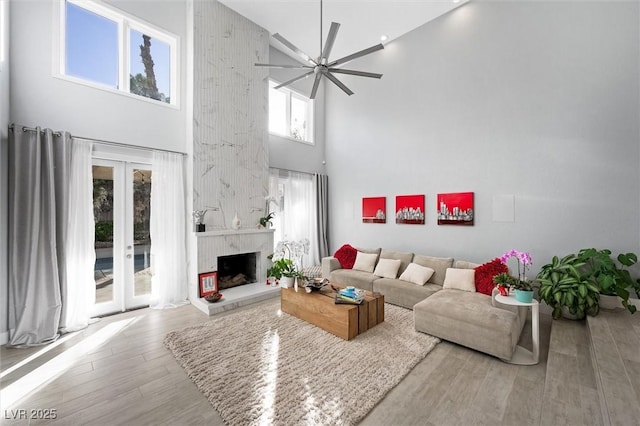 5125 Turnberry Ln, Las Vegas, NV 89113 - living area with a towering ceiling, wood finished floors, ceiling fan, and a fireplace